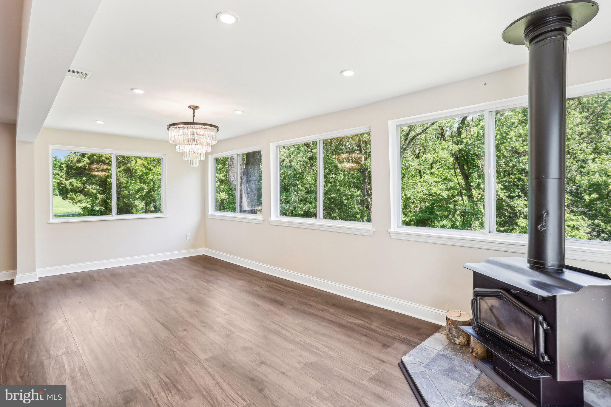 302 Fenwick Road Pilesgrove, NJ 08098 - Photo 12 of 51 a view of an empty room with a window and wooden floor