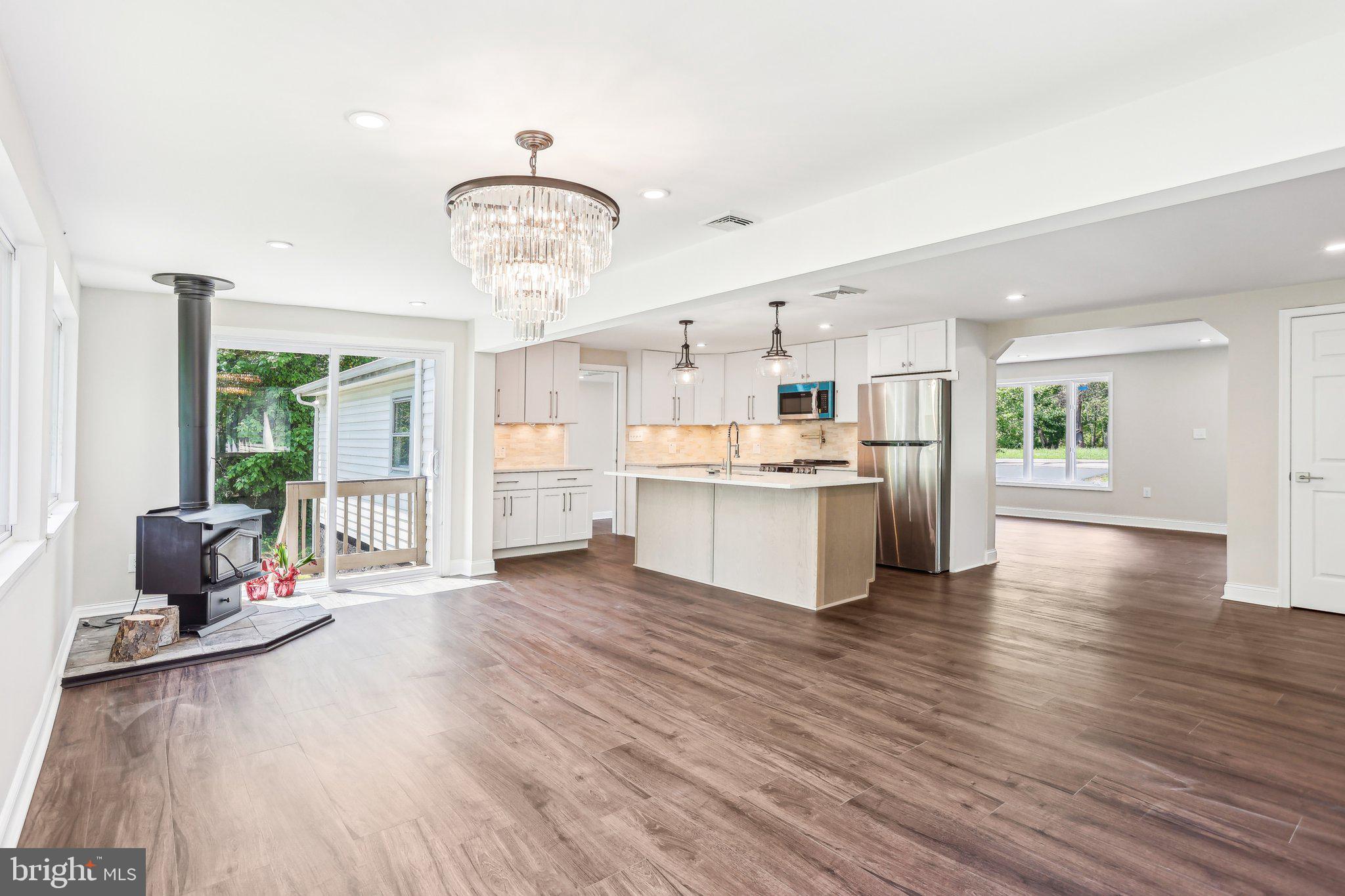 302 Fenwick Road Pilesgrove, NJ 08098 - Photo 14 of 51 a view of a living room and kitchen with furniture wooden floor