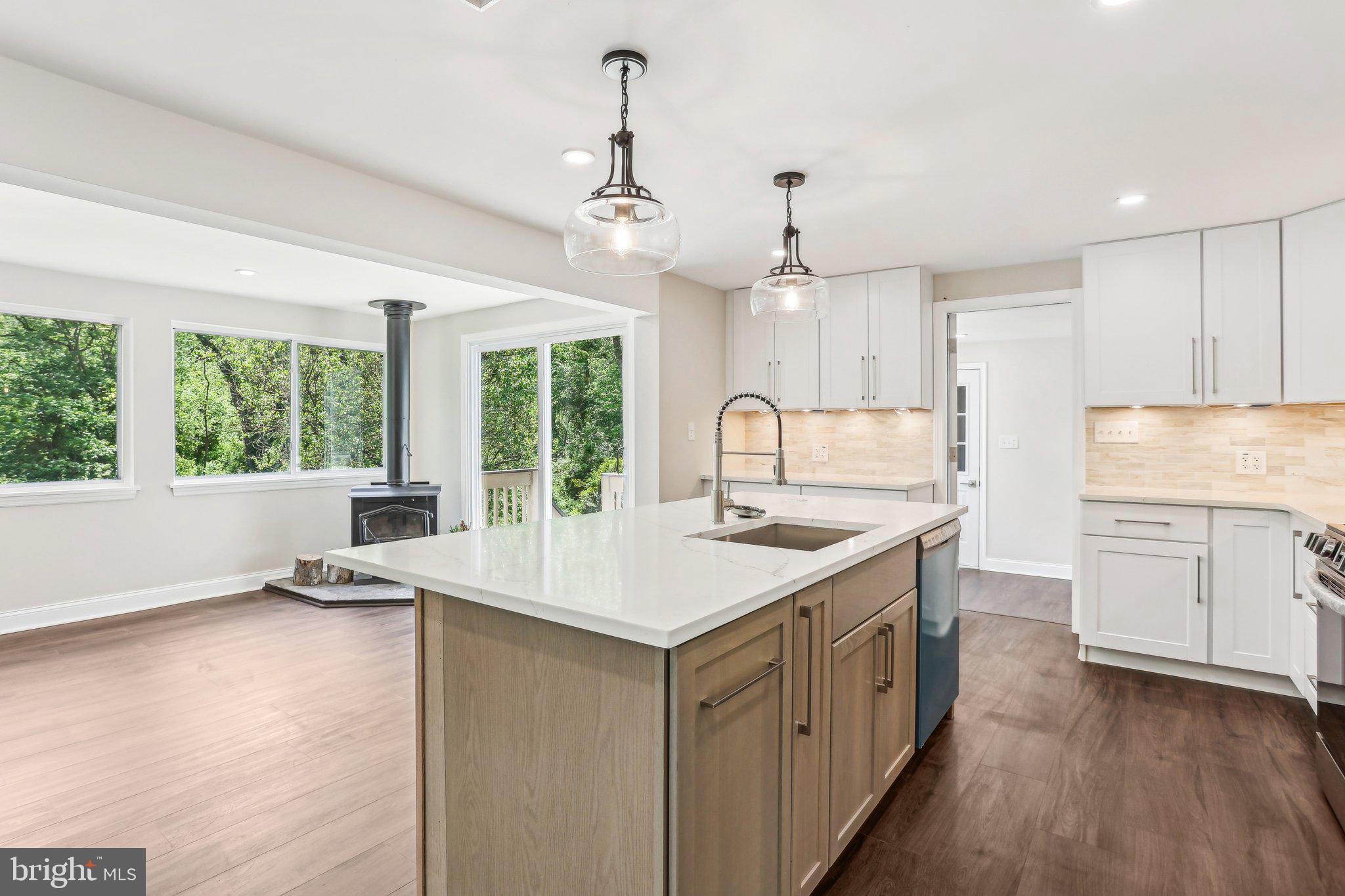 302 Fenwick Road Pilesgrove, NJ 08098 - Photo 15 of 51 a kitchen with a stove a sink a center island and windows