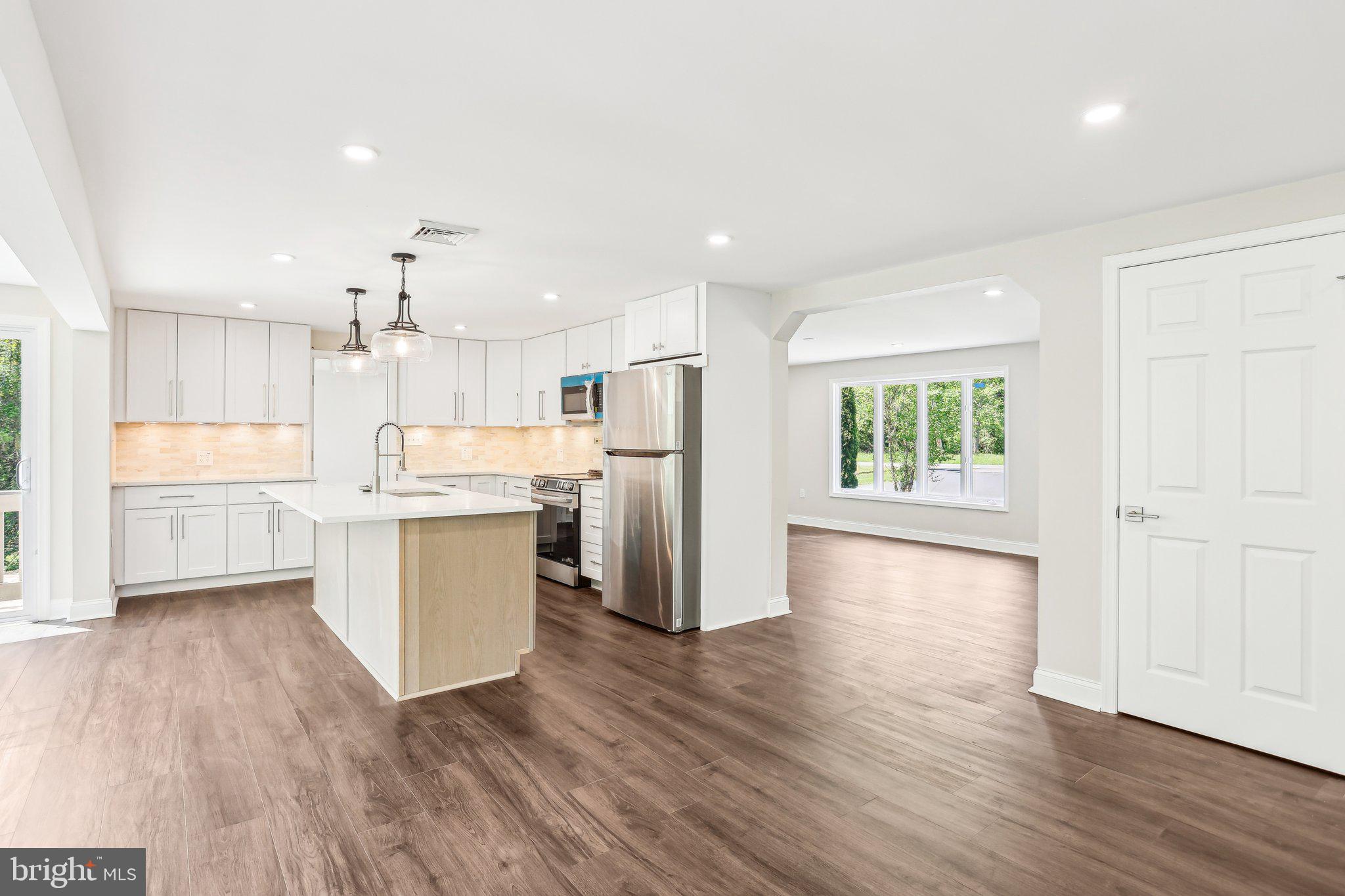 302 Fenwick Road Pilesgrove, NJ 08098 - Photo 16 of 51 a kitchen with a refrigerator and white cabinets