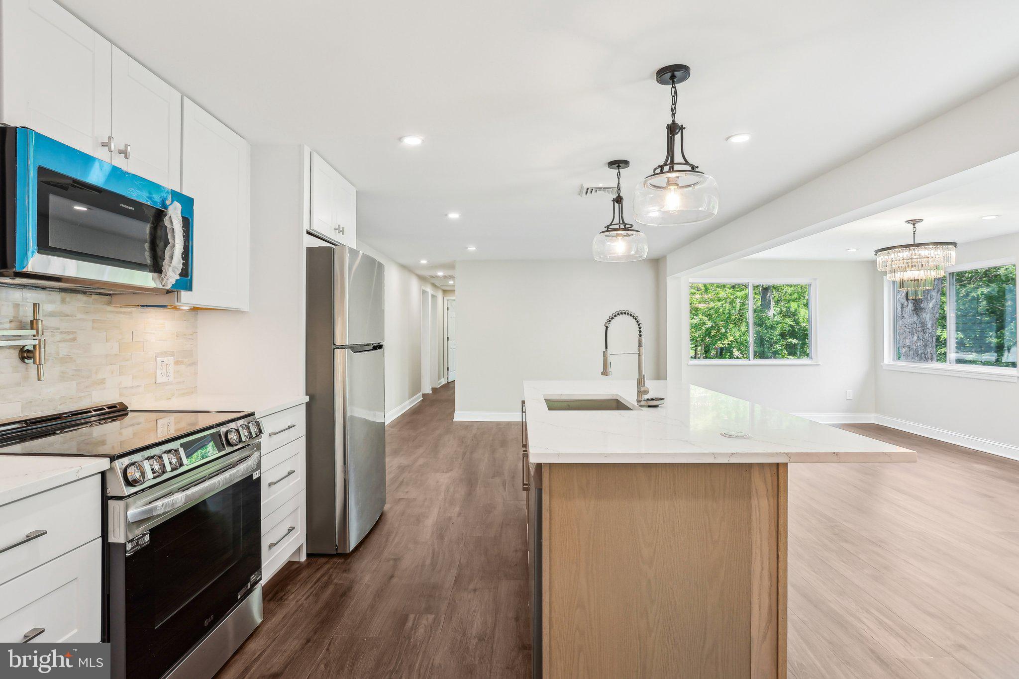 302 Fenwick Road Pilesgrove, NJ 08098 - Photo 19 of 51 a kitchen with stainless steel appliances granite countertop a sink stove and microwave