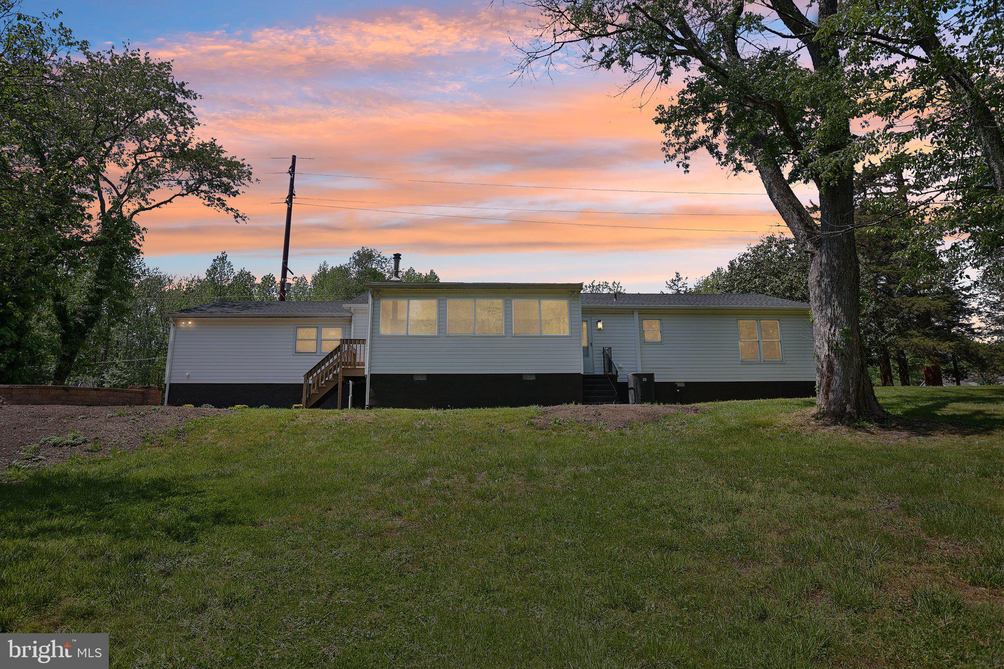 302 Fenwick Road Pilesgrove, NJ 08098 - Photo 2 of 51 a view of a backyard with a garden and trees