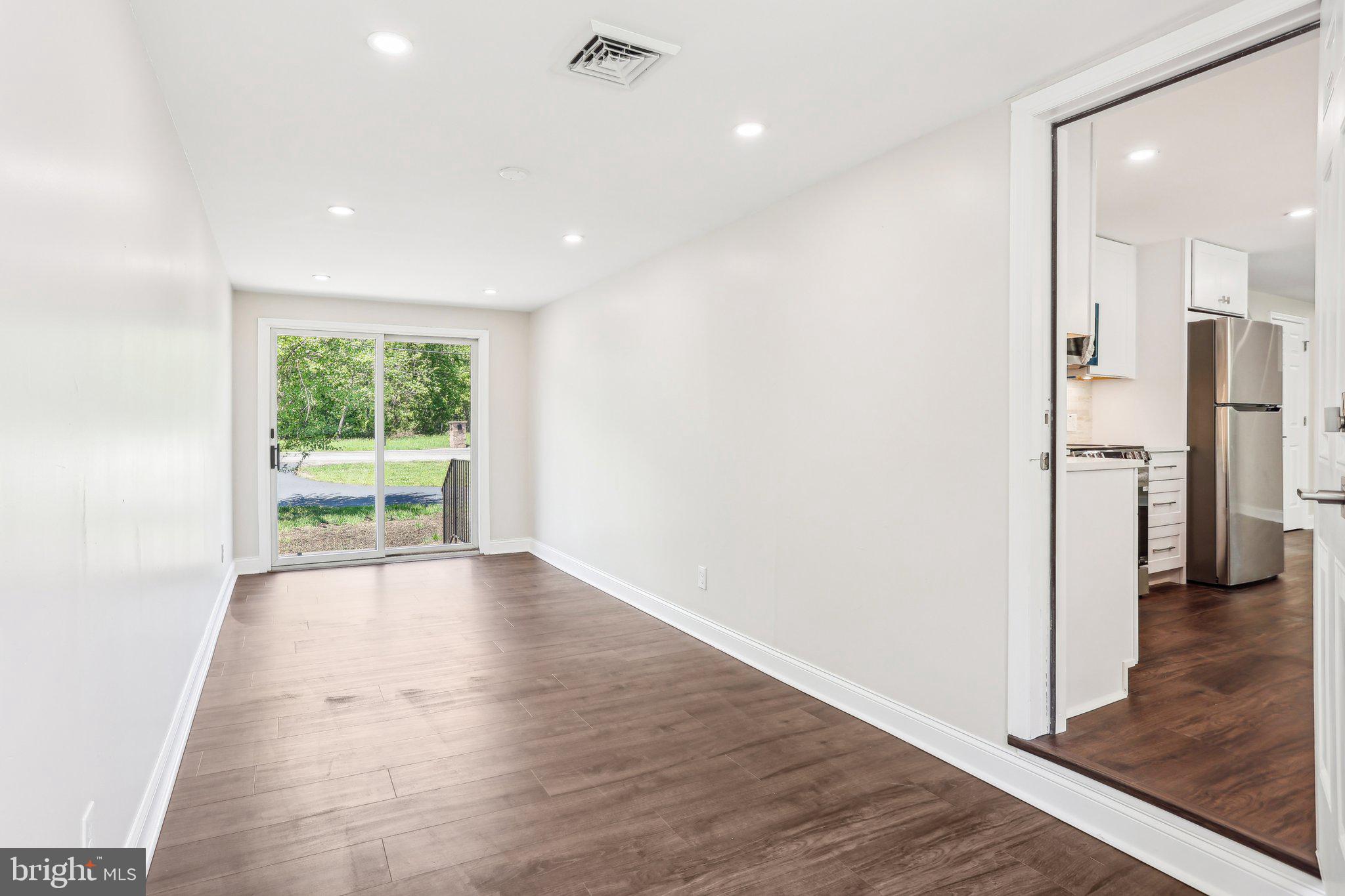 302 Fenwick Road Pilesgrove, NJ 08098 - Photo 22 of 51 a view of a hallway with wooden floor and a living room