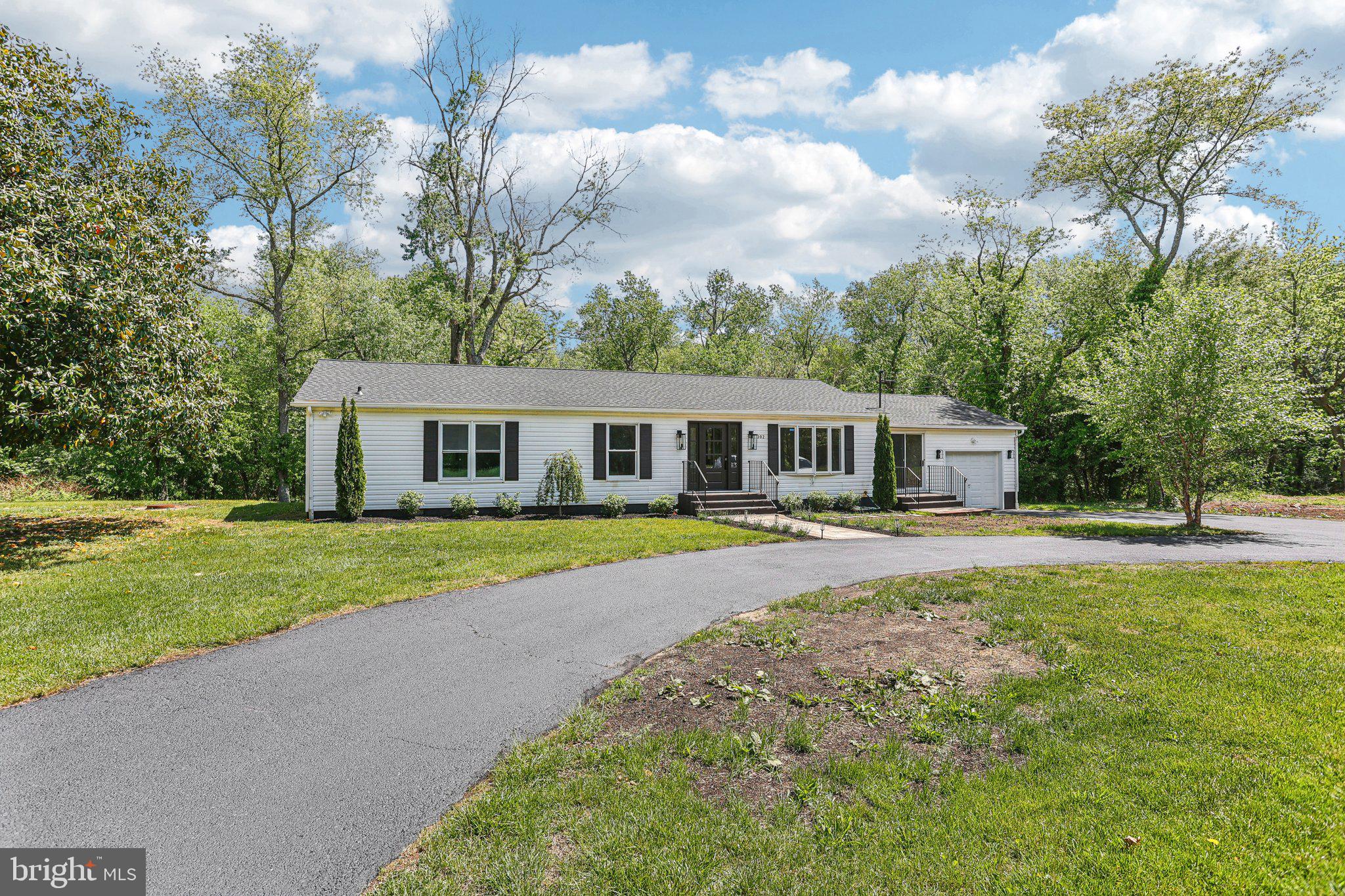 302 Fenwick Road Pilesgrove, NJ 08098 - Photo 4 of 51 a front view of a house with a garden