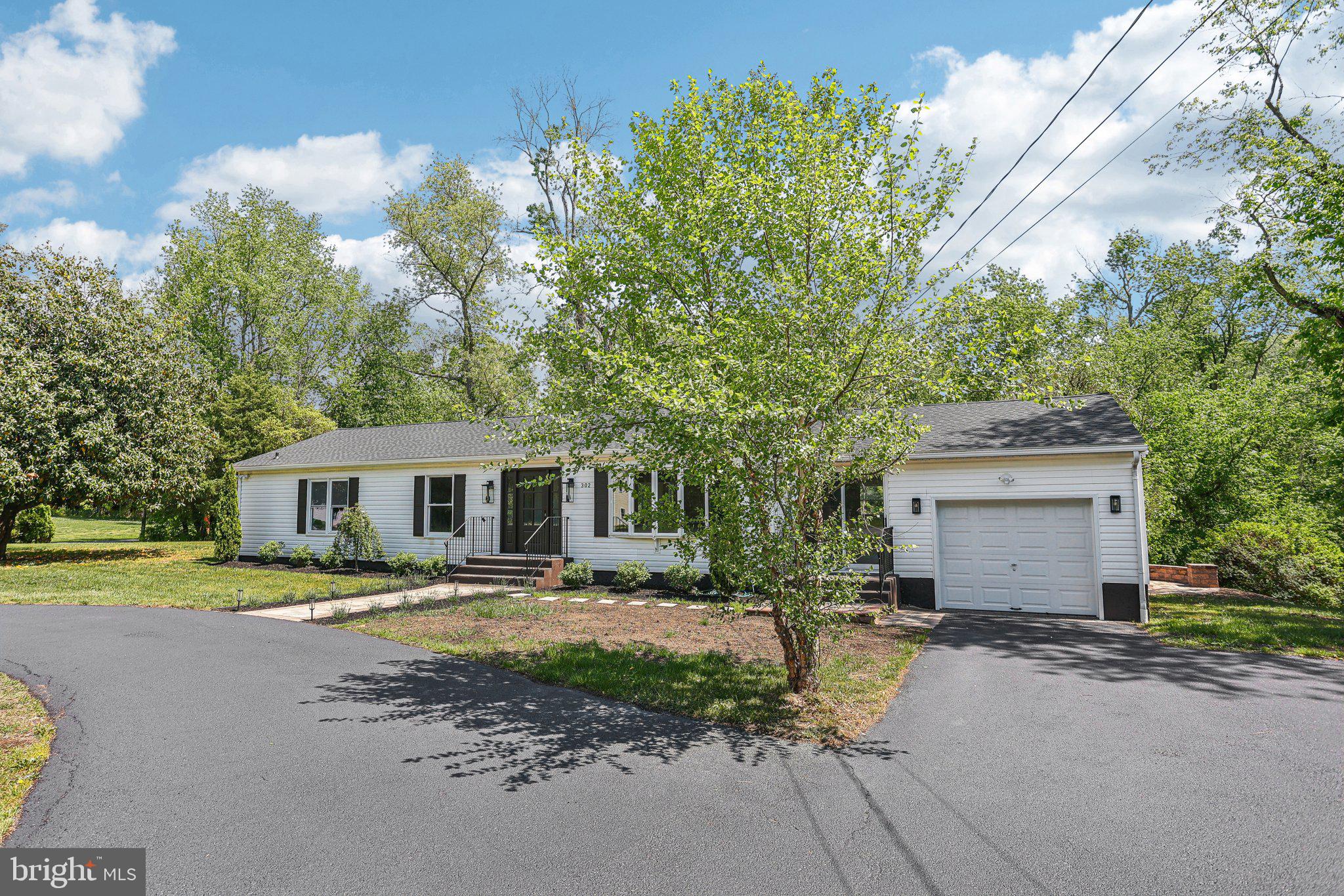 302 Fenwick Road Pilesgrove, NJ 08098 - Photo 5 of 51 a front view of a house with a yard and trees