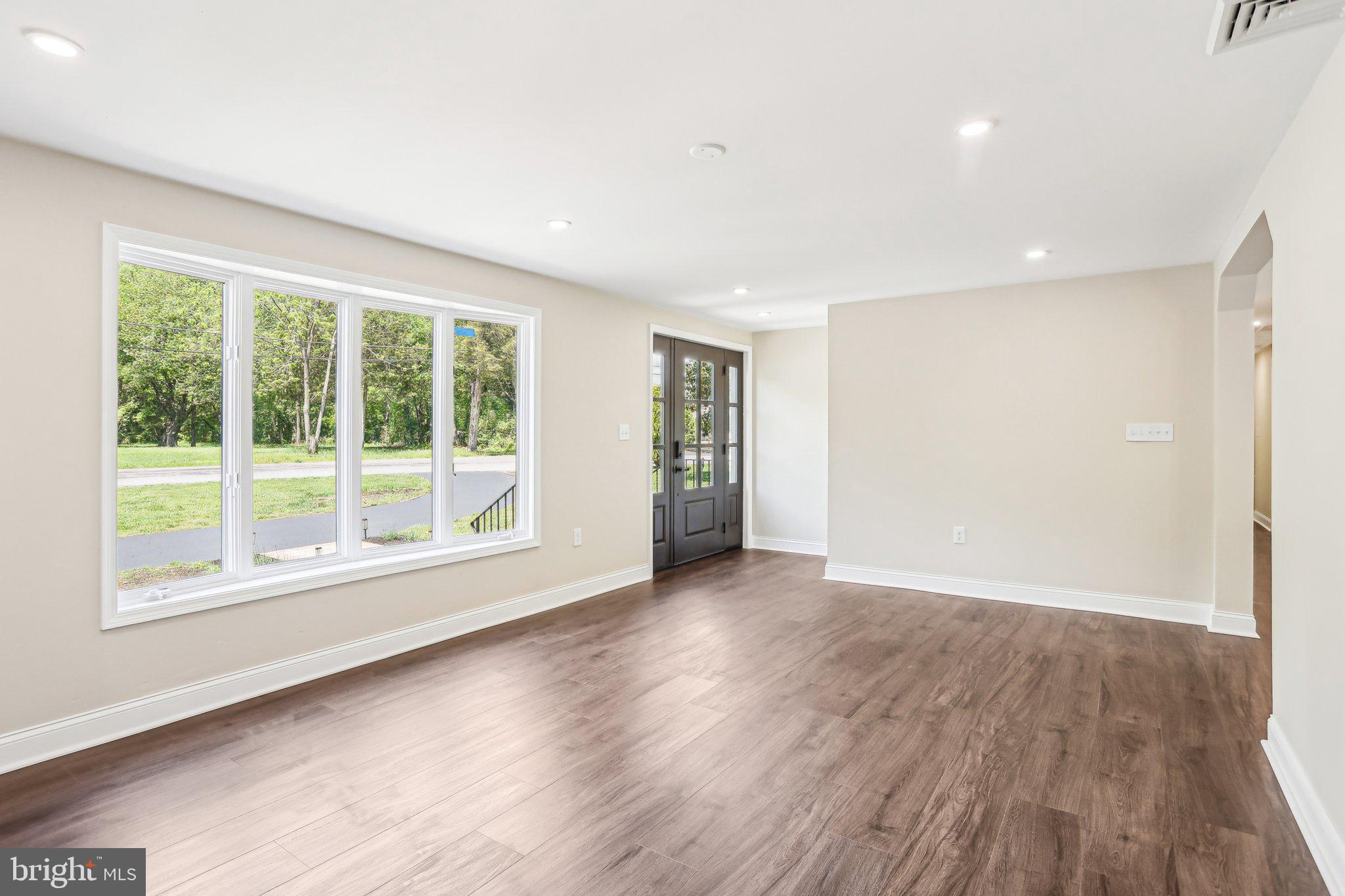 302 Fenwick Road Pilesgrove, NJ 08098 - Photo 7 of 51 a view of an empty room with wooden floor and a window