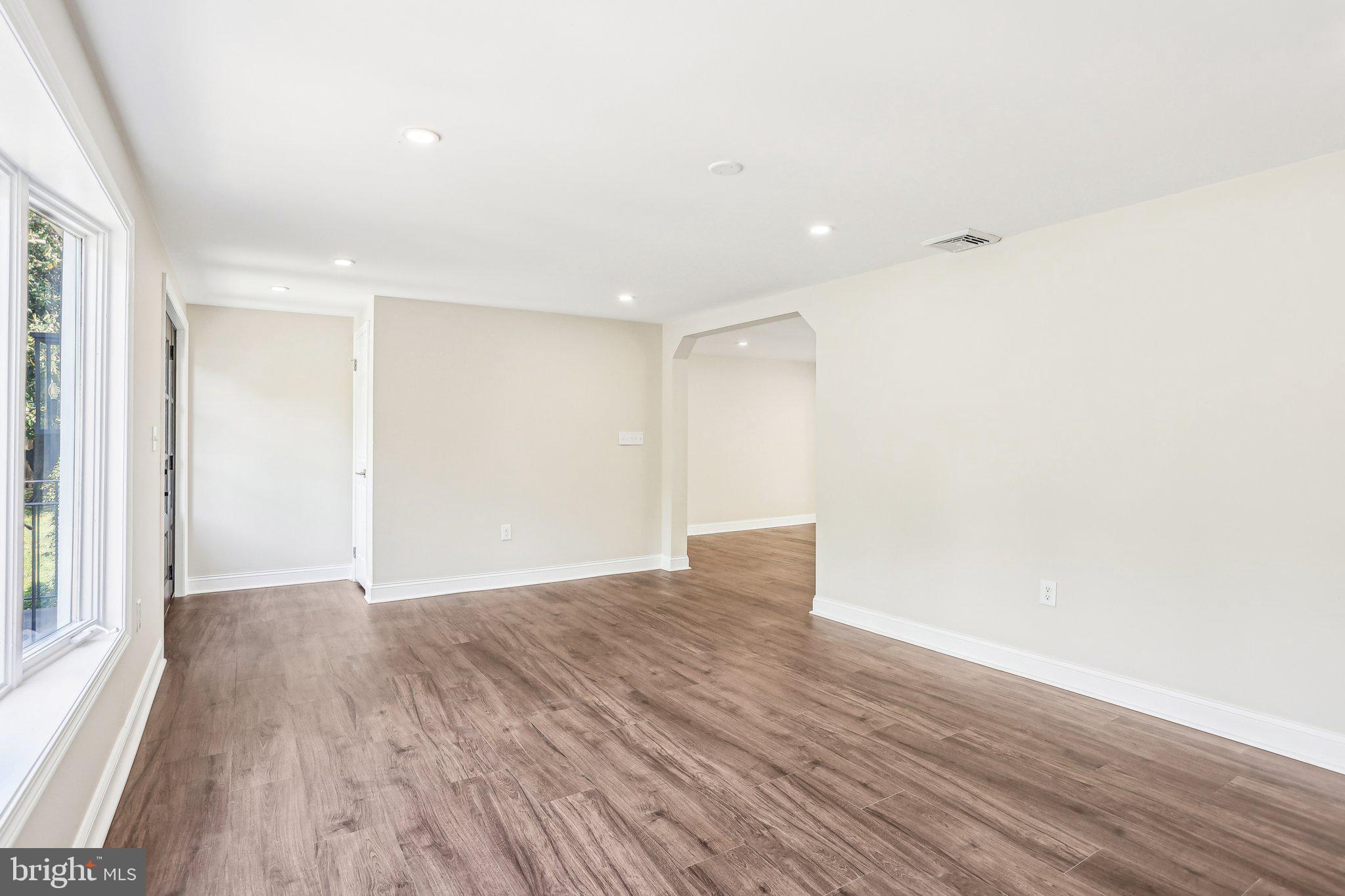 302 Fenwick Road Pilesgrove, NJ 08098 - Photo 8 of 51 a view of an empty room with wooden floor and a window