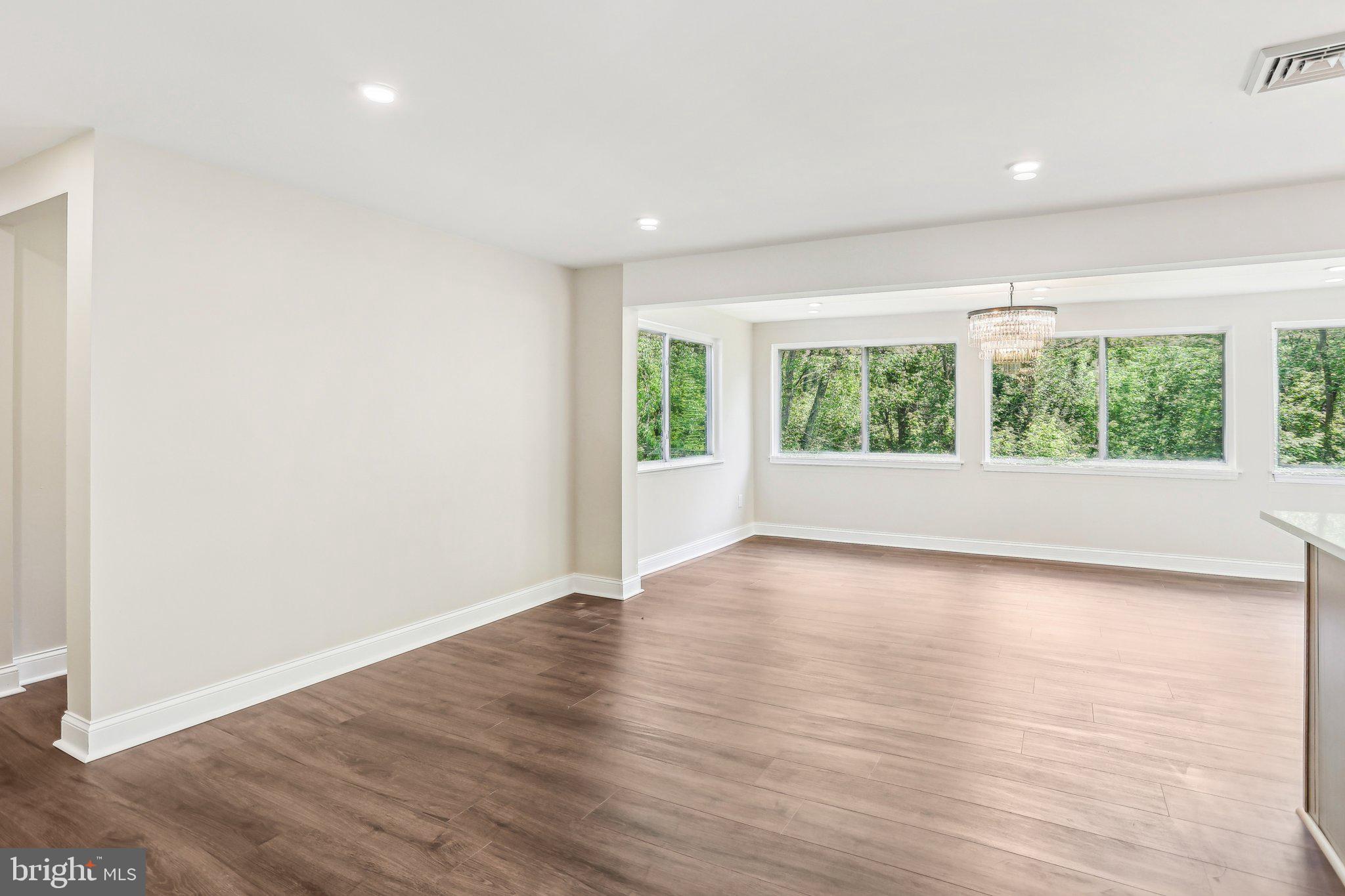 302 Fenwick Road Pilesgrove, NJ 08098 - Photo 10 of 51 an empty room with wooden floor and windows