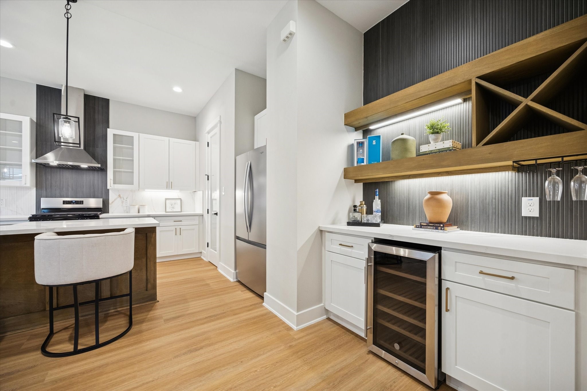 719 Thornton Road, Unit D Houston, TX 77018 - Photo 4 of 45 a kitchen with kitchen island stainless steel appliances a stove refrigerator and cabinets