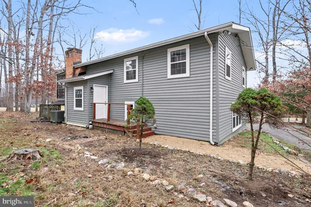 a backyard of a house with potted plants