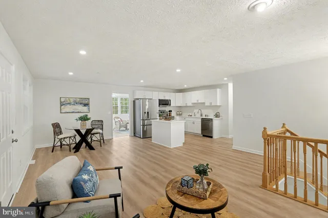 a living room with furniture and kitchen view