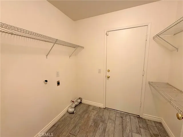 a view of a room with wooden floor