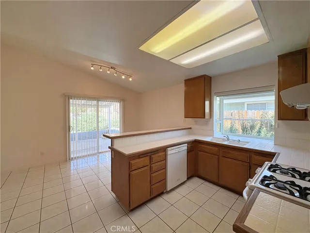 a kitchen with sink cabinets and window