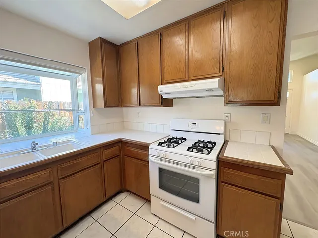a kitchen with cabinets appliances and a window