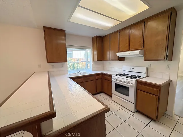 a kitchen with a stove a sink and a microwave