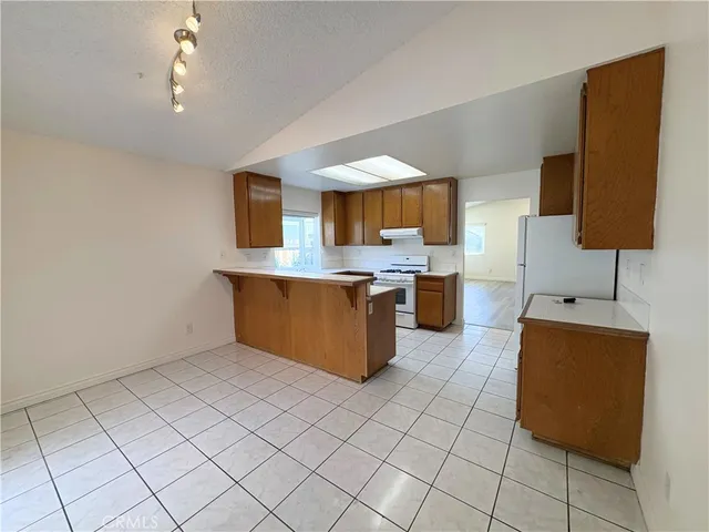 a kitchen with stainless steel appliances granite countertop a sink counter top space and cabinets