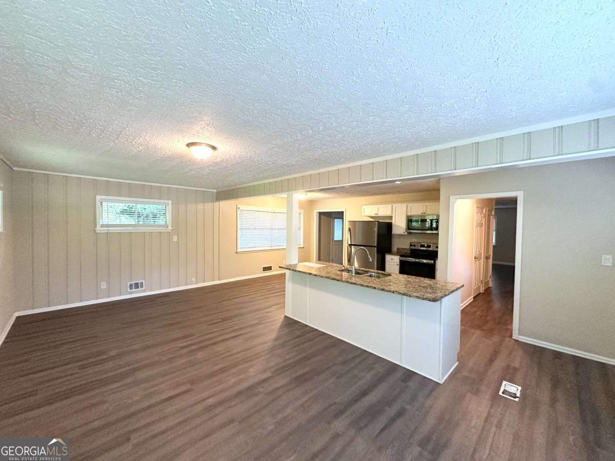 3456 Spring Circle Decatur, GA 30032 - Photo 7 of 22 a view of open kitchen with wooden floor and electronic appliances