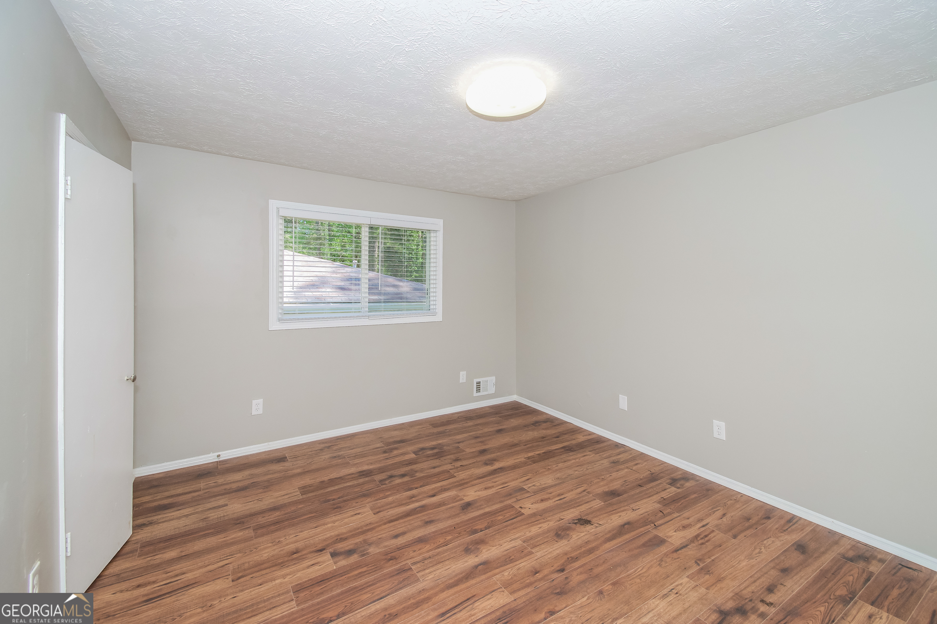 2215 Fairway Circle Southwest Atlanta, GA 30331 - Photo 11 of 18 wooden floor in an empty room with a window