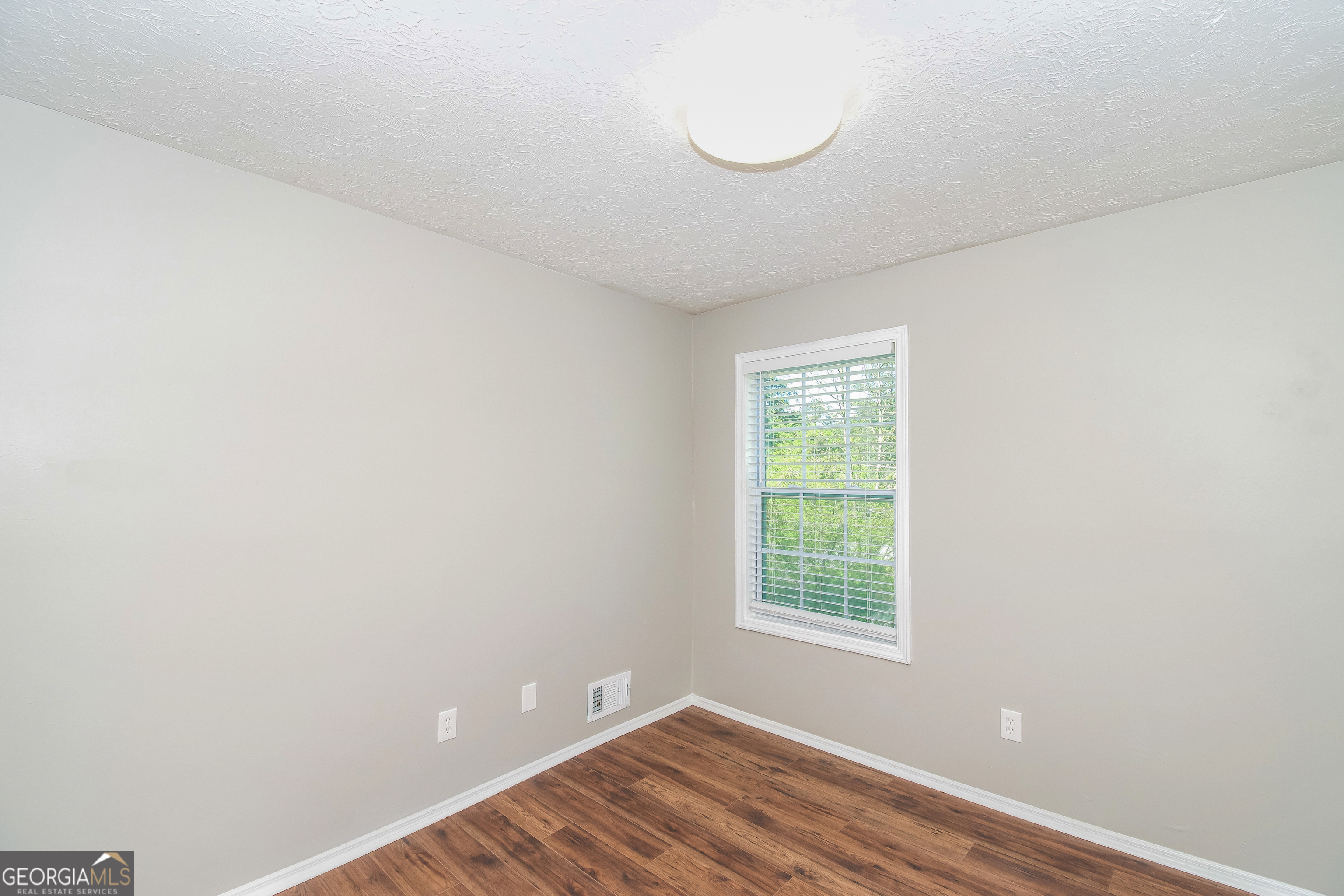 2215 Fairway Circle Southwest Atlanta, GA 30331 - Photo 14 of 18 a view of an empty room with wooden floor and a window
