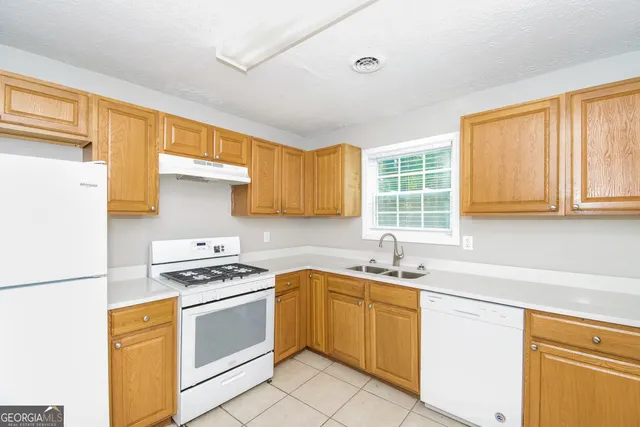 a kitchen with a sink stove and cabinets