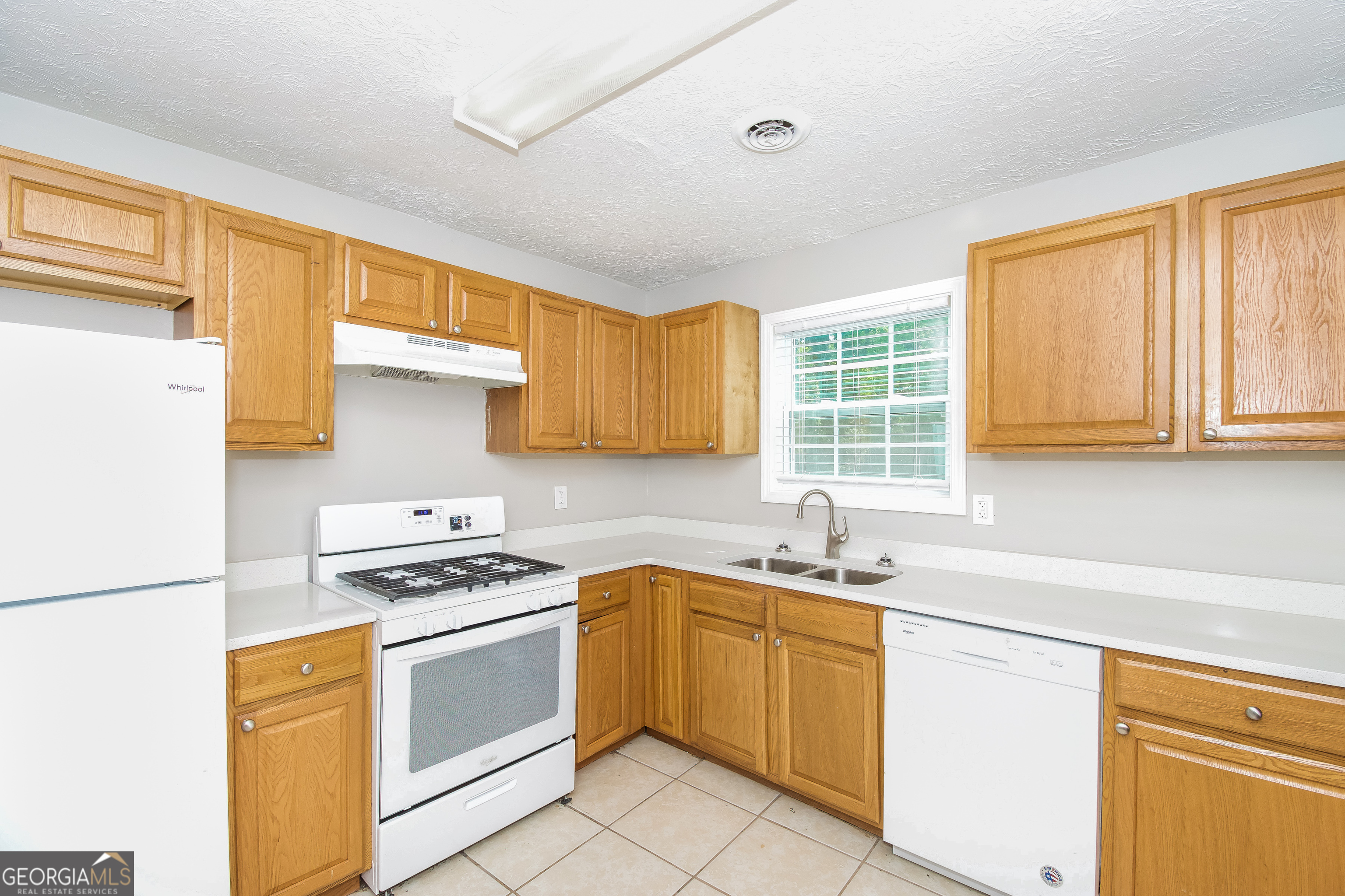 2215 Fairway Circle Southwest Atlanta, GA 30331 - Photo 9 of 18 a kitchen with a sink stove and cabinets