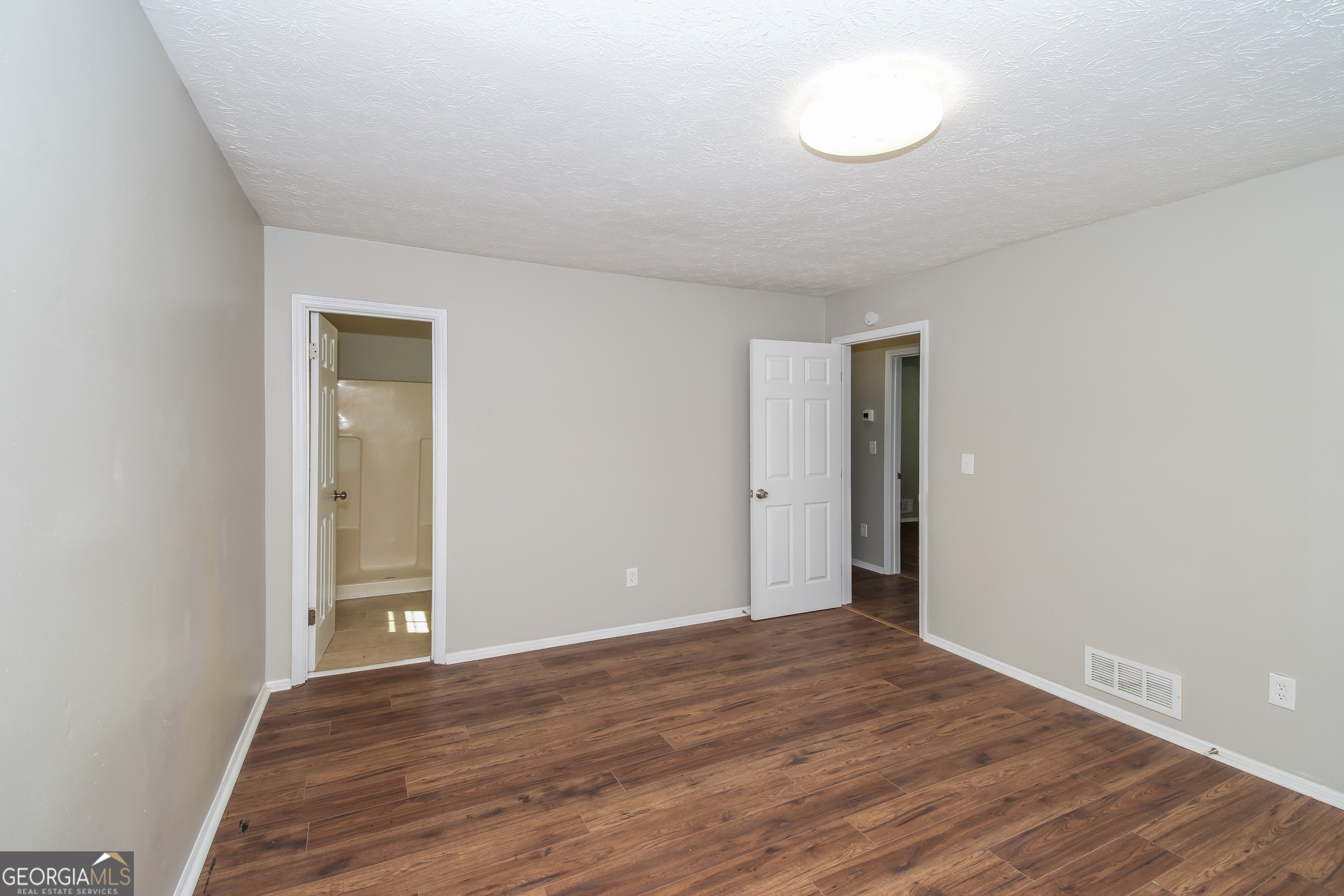 2215 Fairway Circle Southwest Atlanta, GA 30331 - Photo 10 of 18 an empty room with wooden floor and windows
