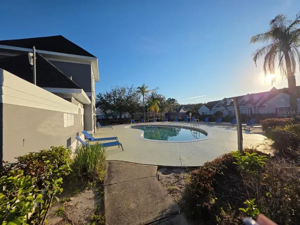 a view of a swimming pool with a yard
