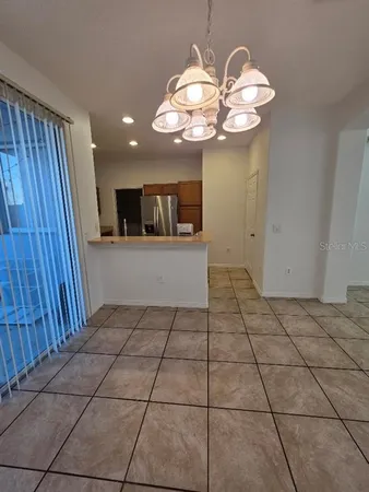 a view of a hallway with a chandelier