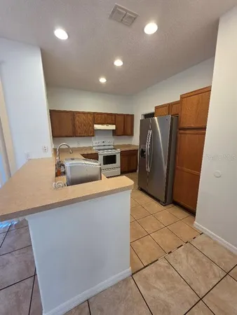 a kitchen with stainless steel appliances a refrigerator sink and microwave