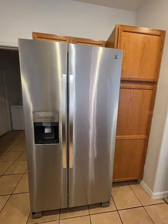 a view of a refrigerator in kitchen