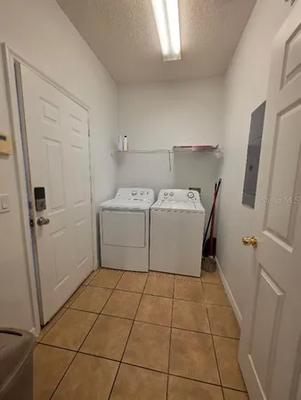 a utility room with cabinets washer and dryer