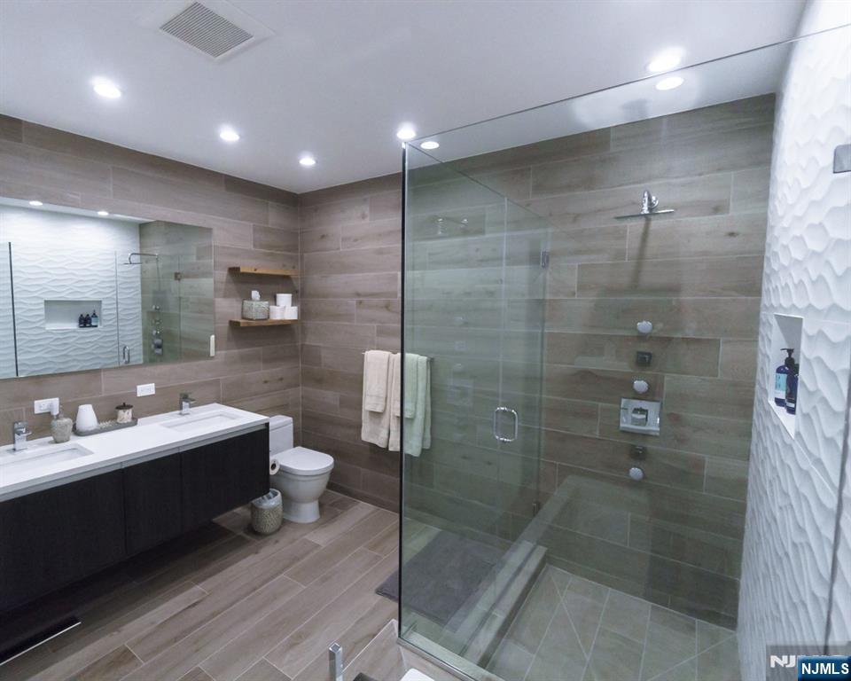 314 The Promenade Edgewater, NJ 07020 - Photo 20 of 37 a bathroom with a double vanity sink mirror and toilet
