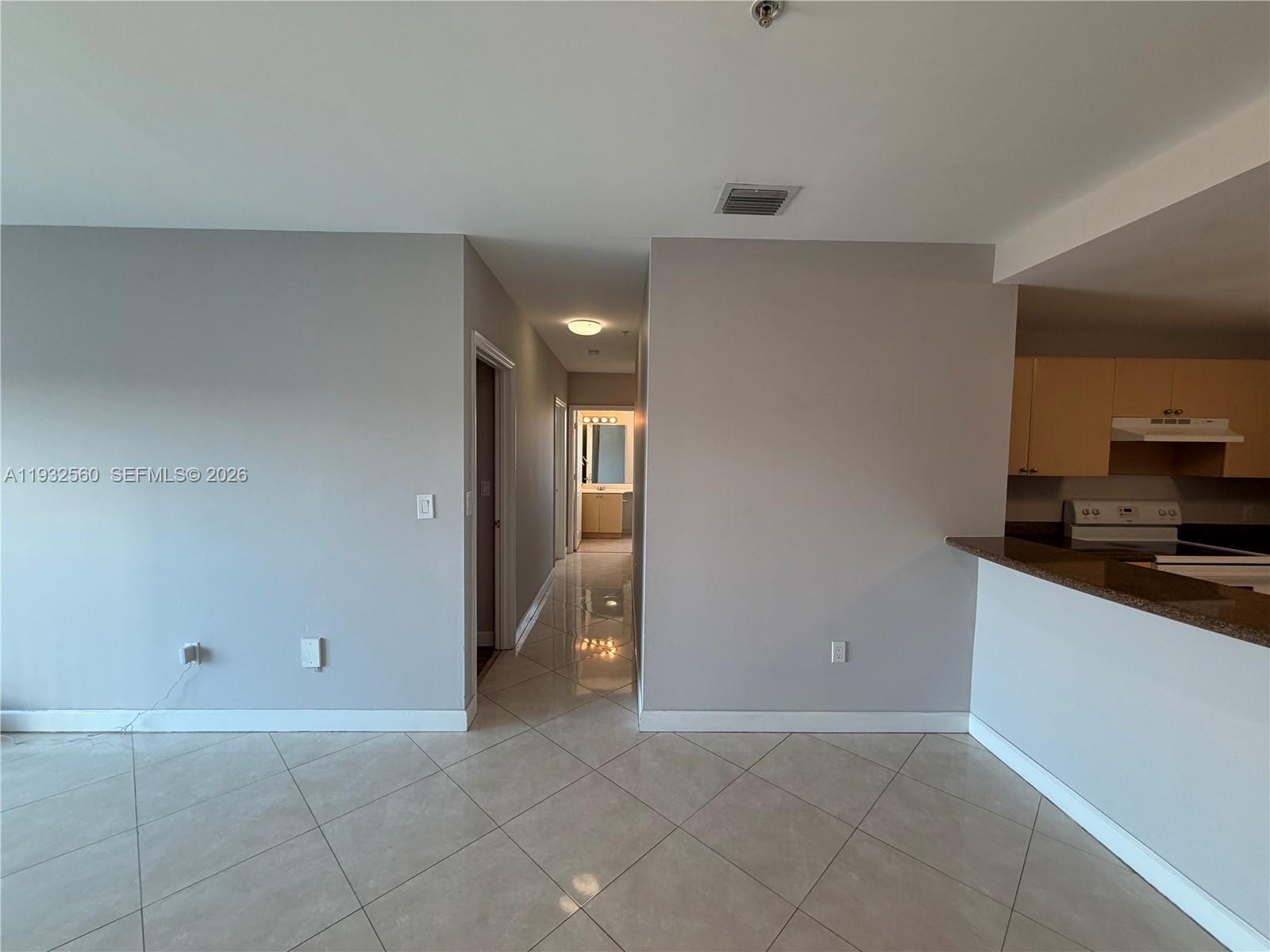 2280 Southwest 32nd Avenue, Unit 216 Miami, FL 33145 - Photo 11 of 34 a view of a kitchen with a sink and a refrigerator