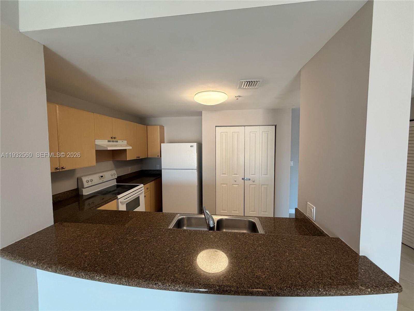 2280 Southwest 32nd Avenue, Unit 216 Miami, FL 33145 - Photo 12 of 34 a kitchen with a table and chairs