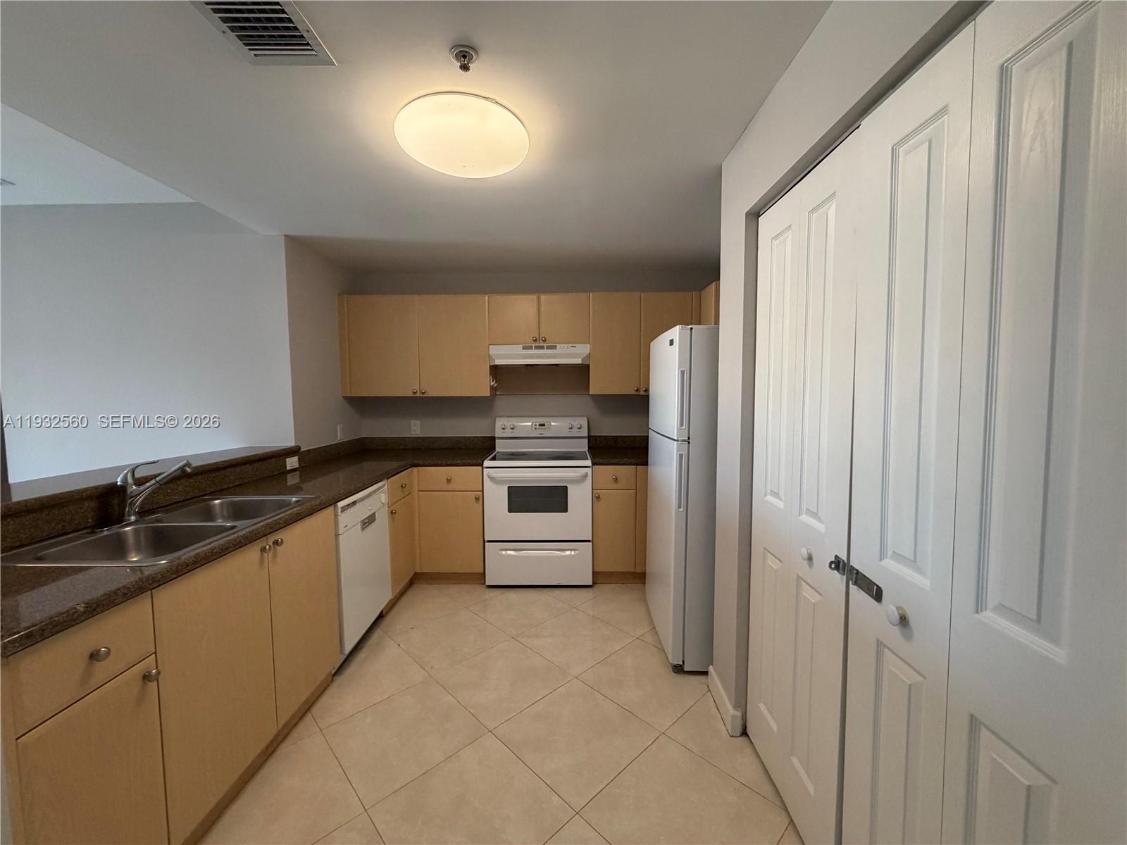 2280 Southwest 32nd Avenue, Unit 216 Miami, FL 33145 - Photo 15 of 34 a large kitchen with cabinets and stainless steel appliances