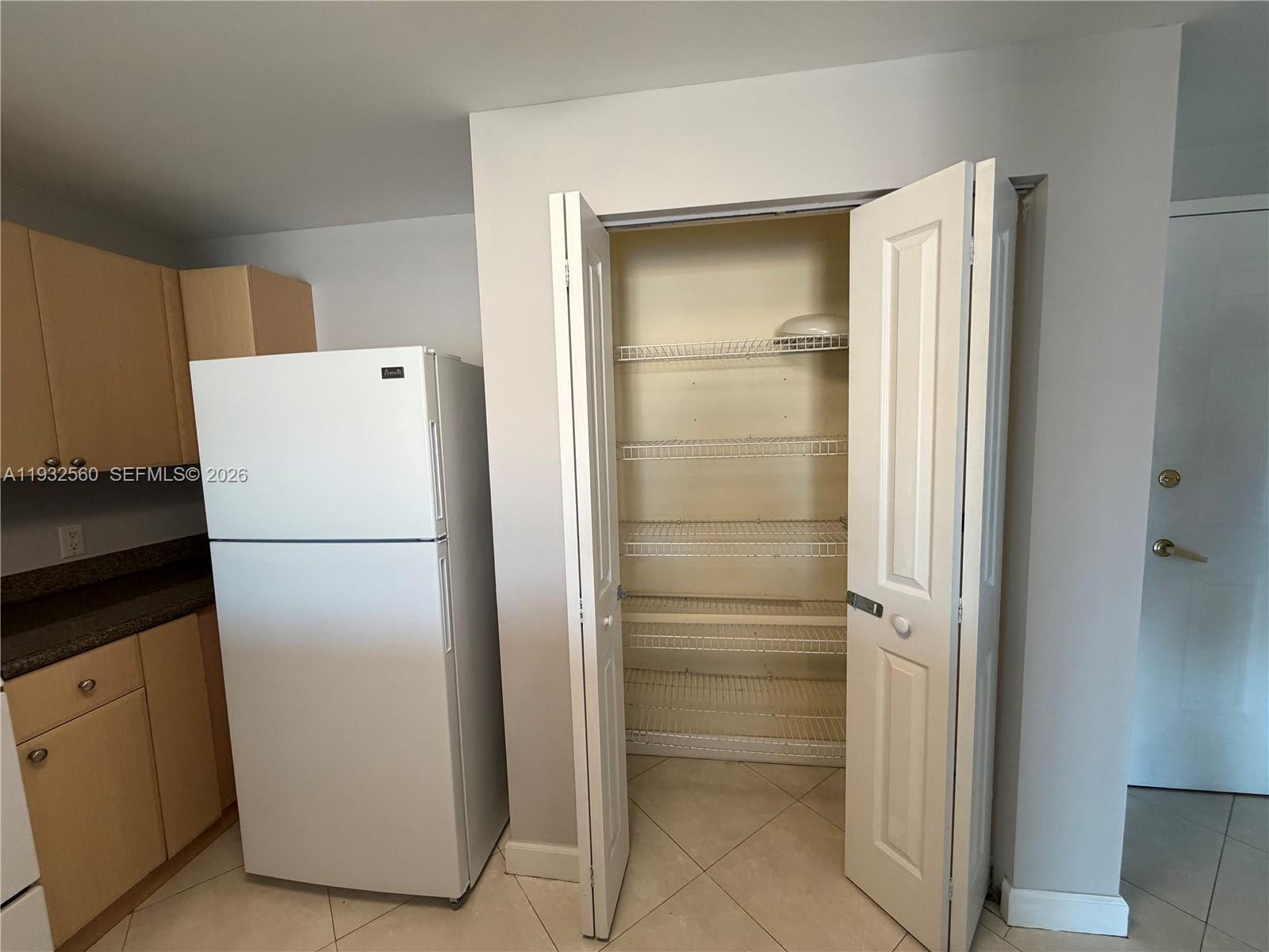 2280 Southwest 32nd Avenue, Unit 216 Miami, FL 33145 - Photo 30 of 34 a white refrigerator freezer sitting in a kitchen