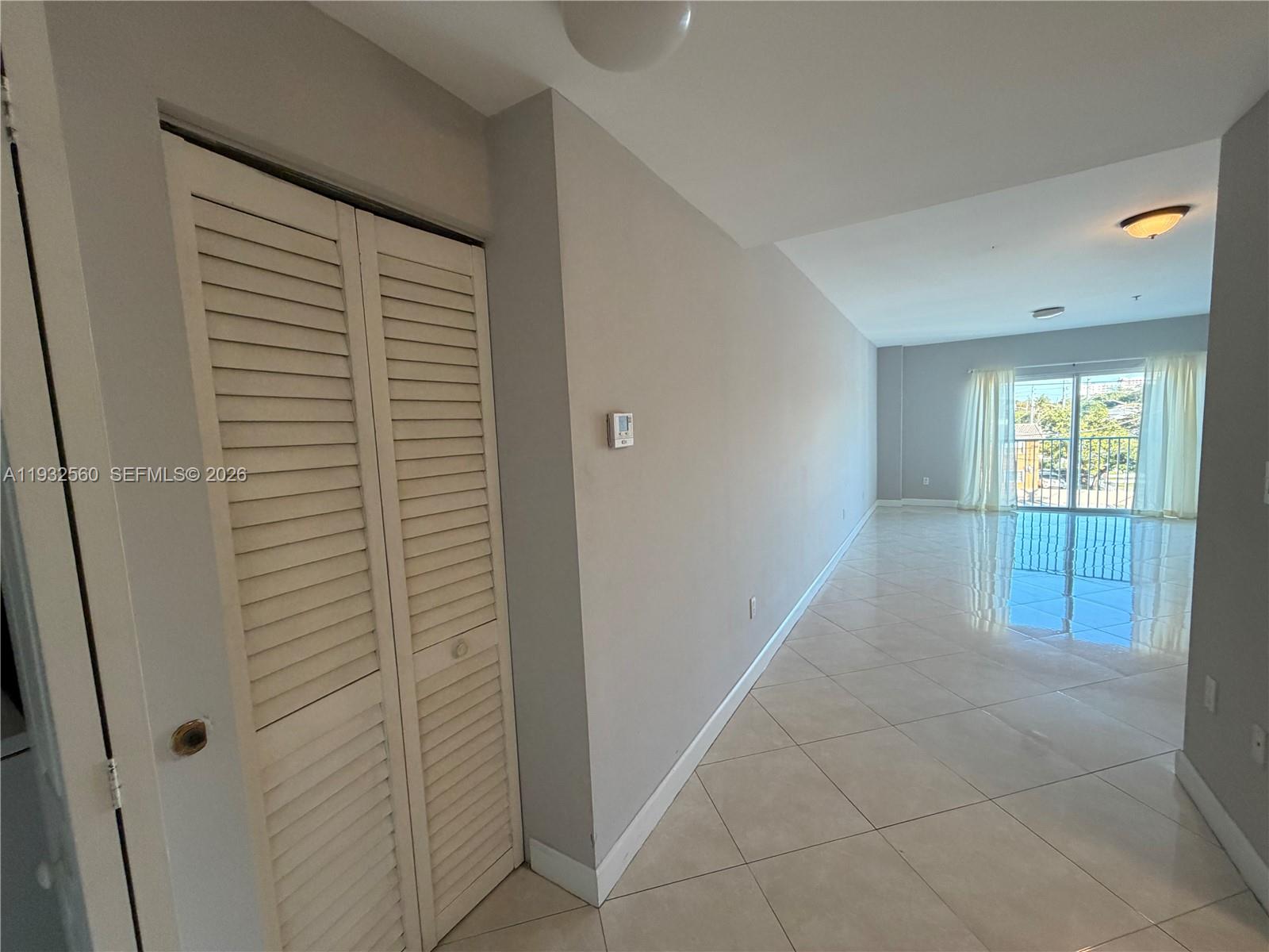 2280 Southwest 32nd Avenue, Unit 216 Miami, FL 33145 - Photo 6 of 34 a view of an empty room with glass door and a window