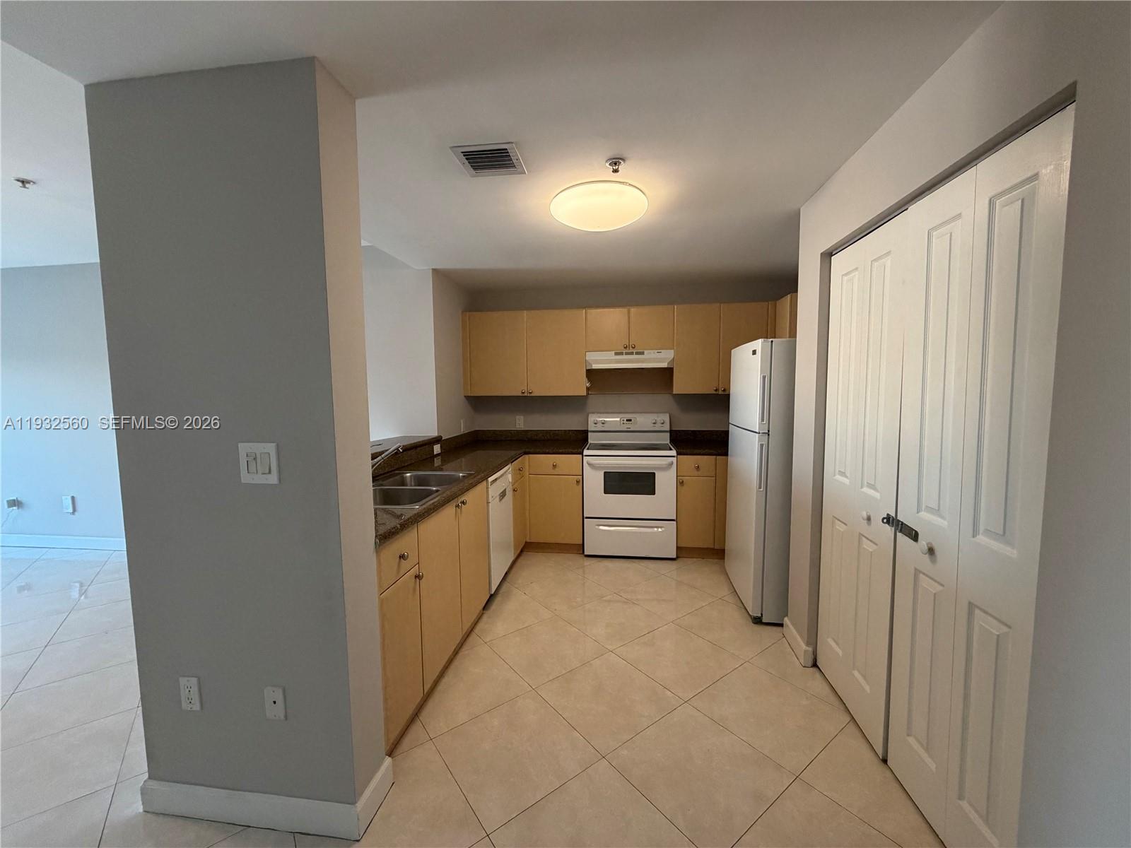 2280 Southwest 32nd Avenue, Unit 216 Miami, FL 33145 - Photo 10 of 34 a kitchen with stainless steel appliances a refrigerator and a stove top oven
