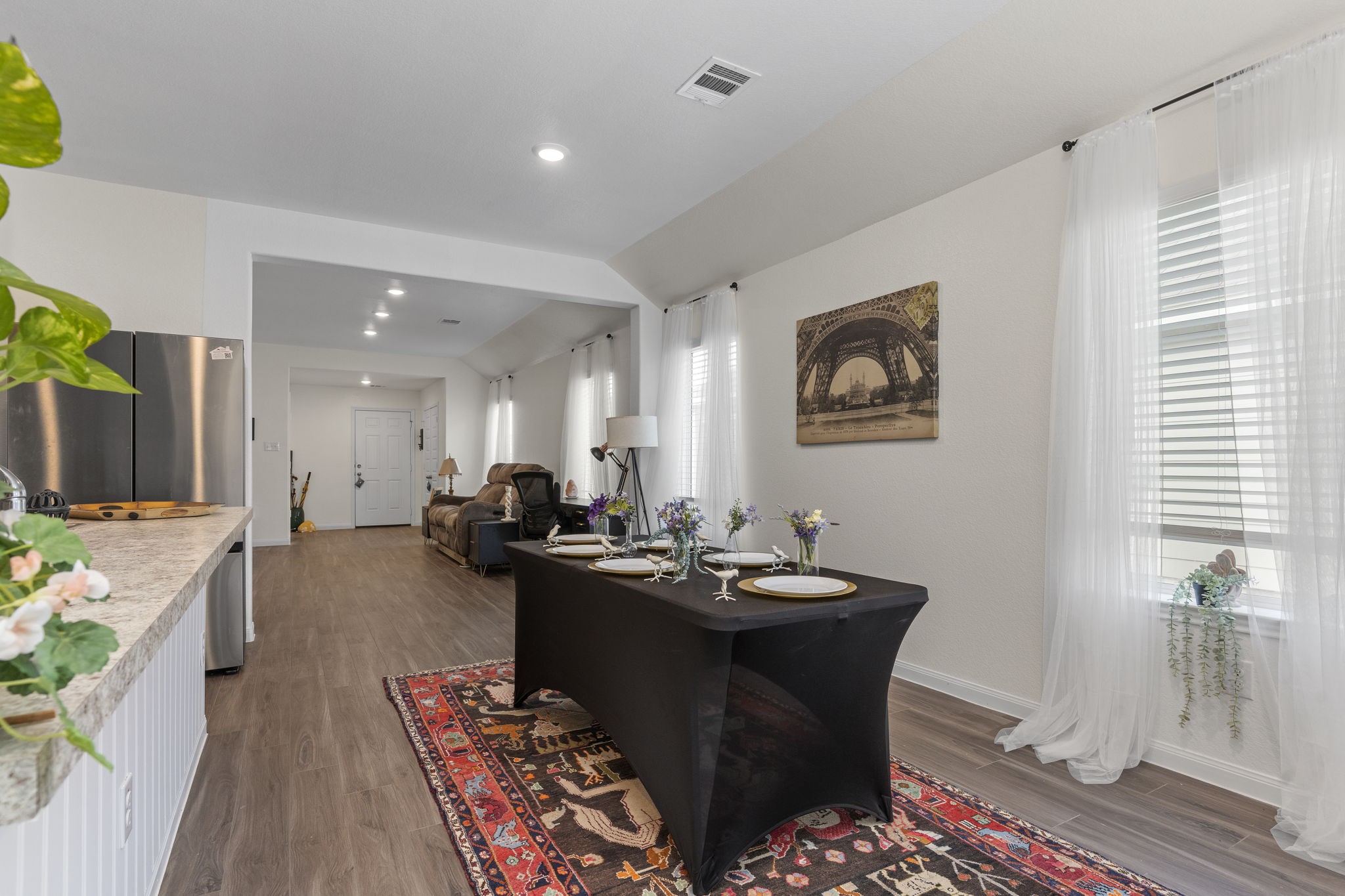 22565 Cormorant Court Splendora, TX 77372 - Photo 21 of 50 a dining hall with granite countertop a stove top oven a dining table and chairs with wooden floor
