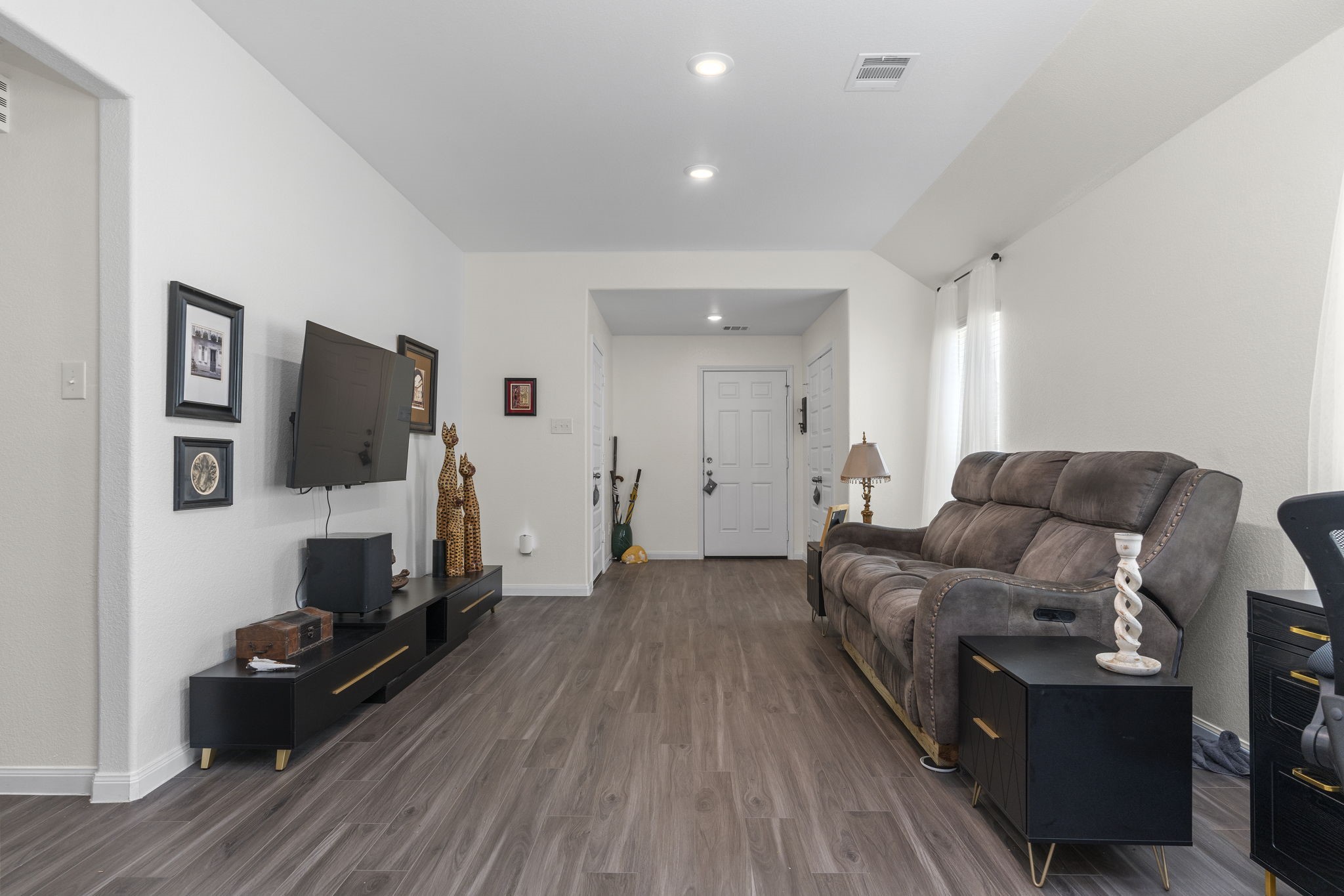 22565 Cormorant Court Splendora, TX 77372 - Photo 9 of 50 a living room with furniture and a flat screen tv