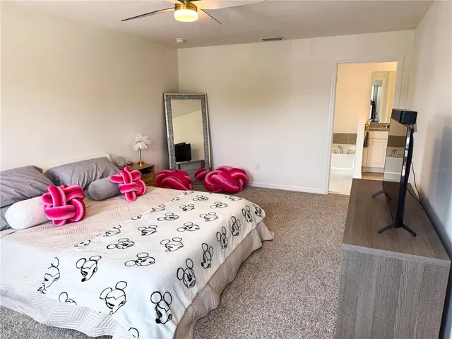 a bedroom with a bed and a dresser