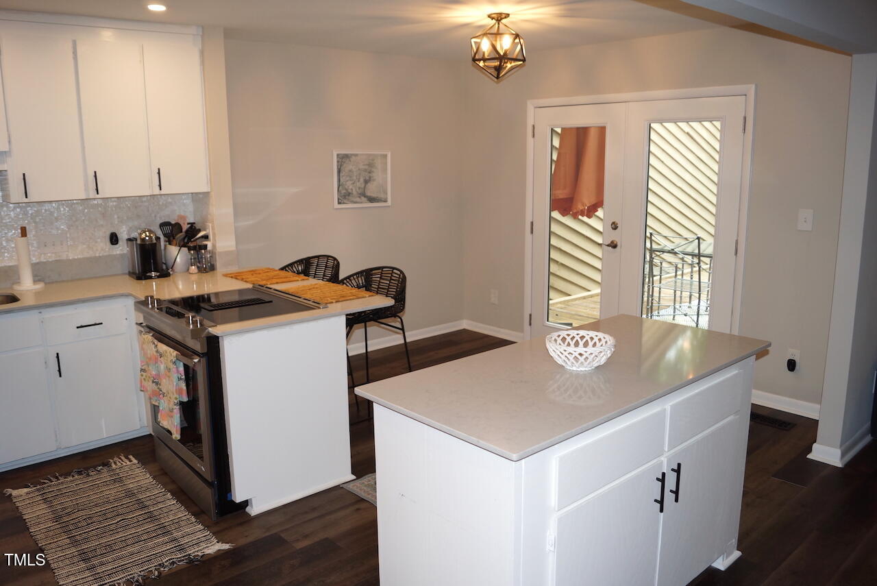 80 Stoneridge Road Durham, NC 27705 - Photo 4 of 27 a kitchen that has a sink and a stove in it