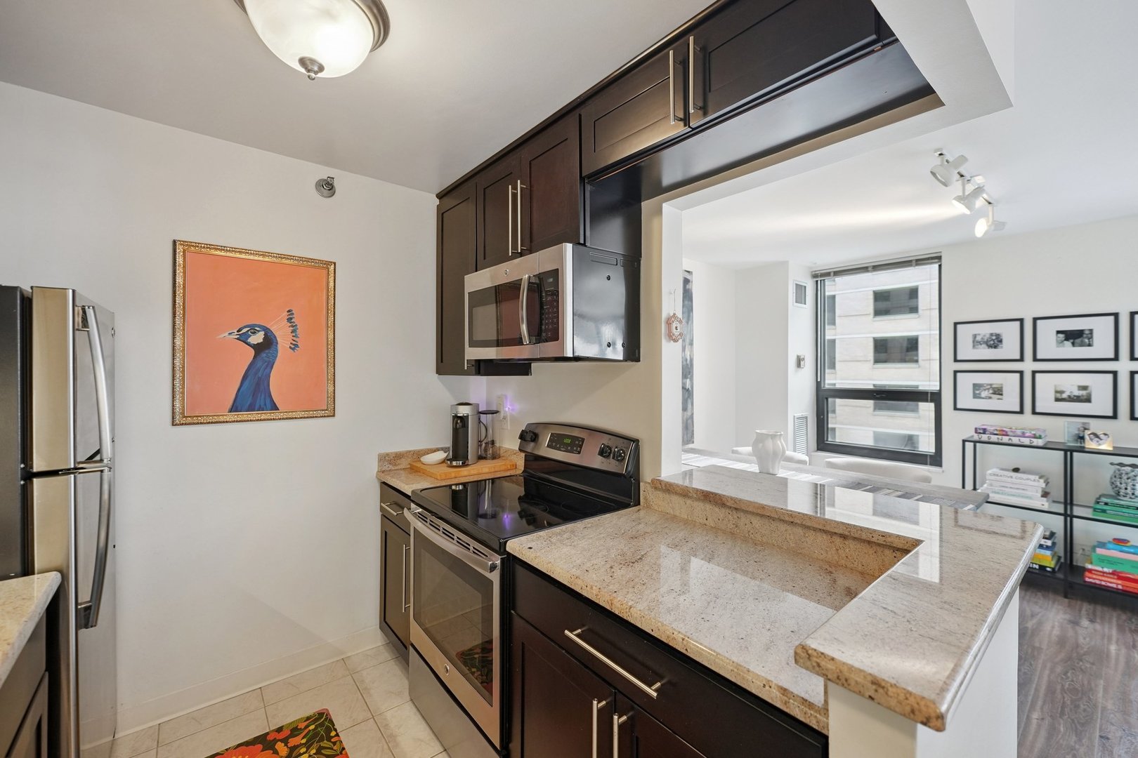 401 East Ontario Street, Unit 2506 Chicago, IL 60611 - Photo 6 of 12 a kitchen with stainless steel appliances granite countertop a sink stove and refrigerator
