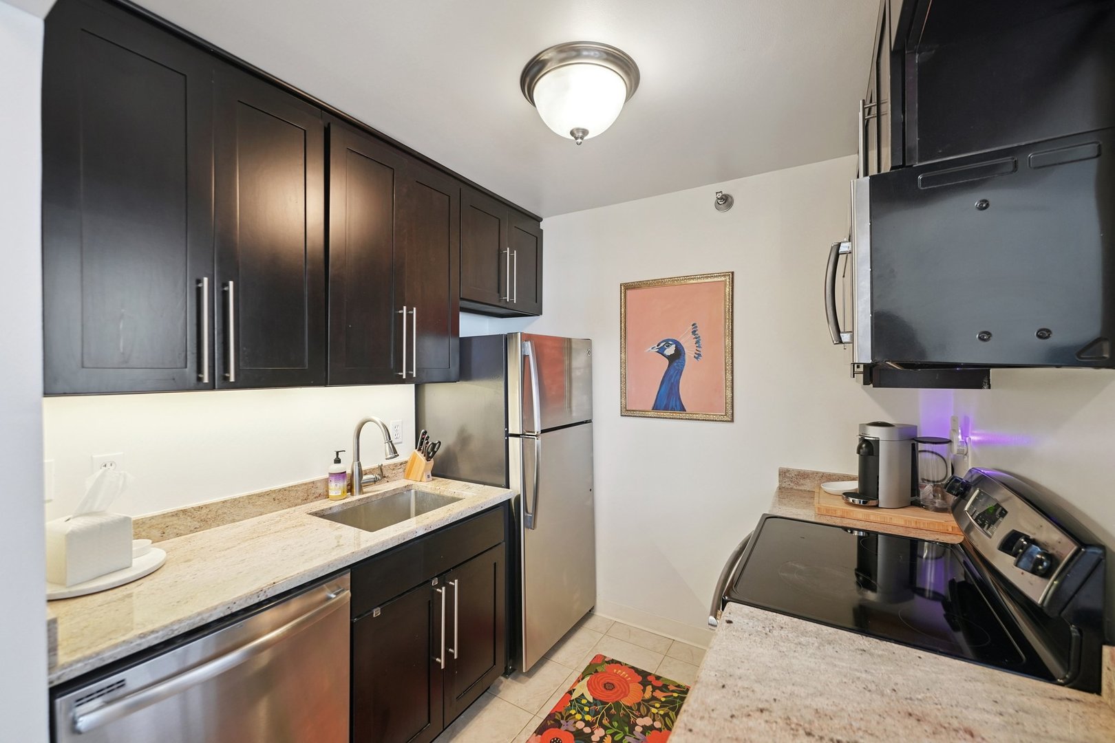 401 East Ontario Street, Unit 2506 Chicago, IL 60611 - Photo 7 of 12 a kitchen with a sink and a stove top oven