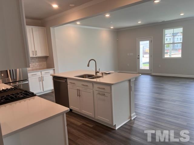 2403 Chert Lane, Unit 2403 Raleigh, NC 27610 - Photo 4 of 19 a kitchen that has a sink in it and wooden floors
