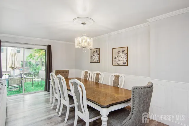 a view of a dining room with furniture wooden floor and a floor to ceiling window