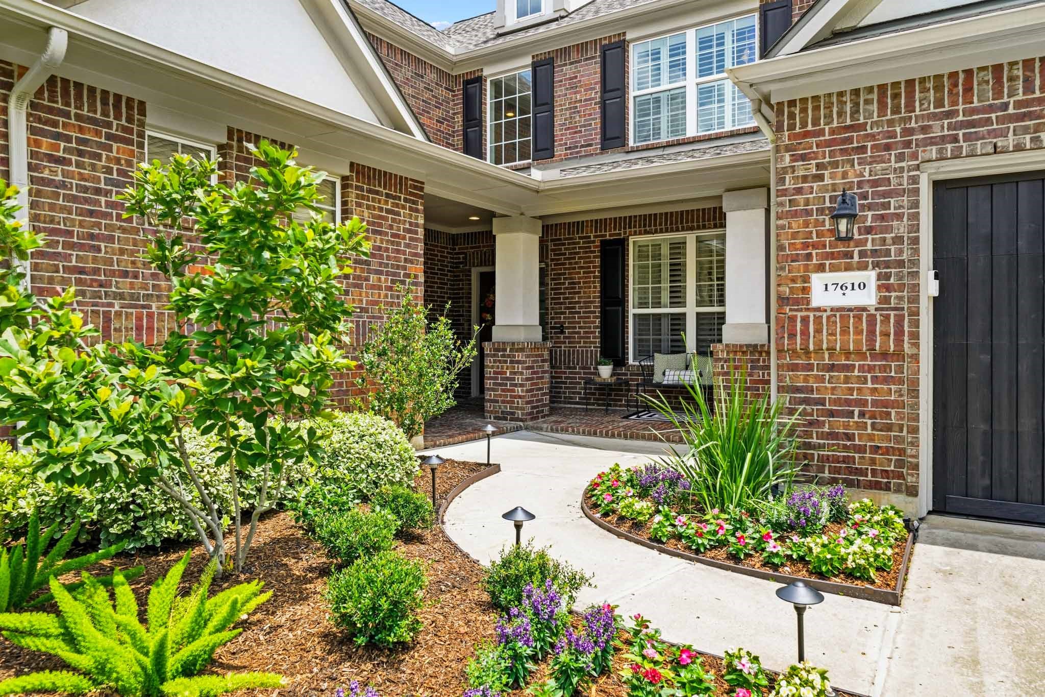 17610 Strackfield Lane Tomball, TX 77377 - Photo 2 of 50 Beautifully positioned on a tree-lined corner lot, the home's timeless brick and stucco exterior is complemented by manicured grounds and professionally installed landscape lighting.
