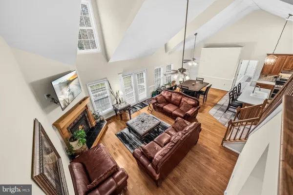 a living room with furniture large window and a fireplace