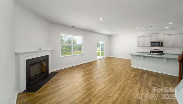 a view of a kitchen with microwave and stove top oven