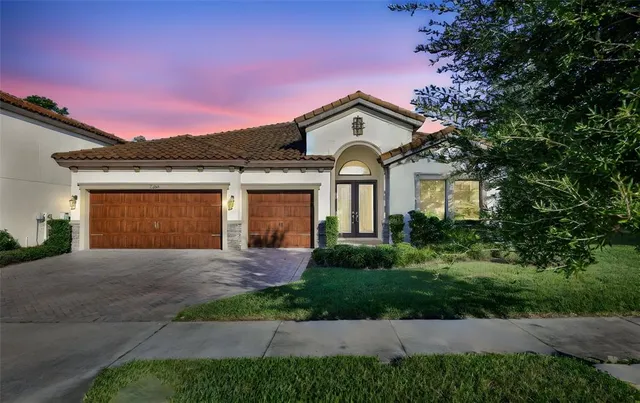 a front view of a house with a yard and garage